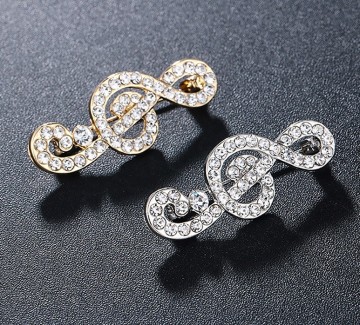 Broche vioolsleutel glinster goud en zilver